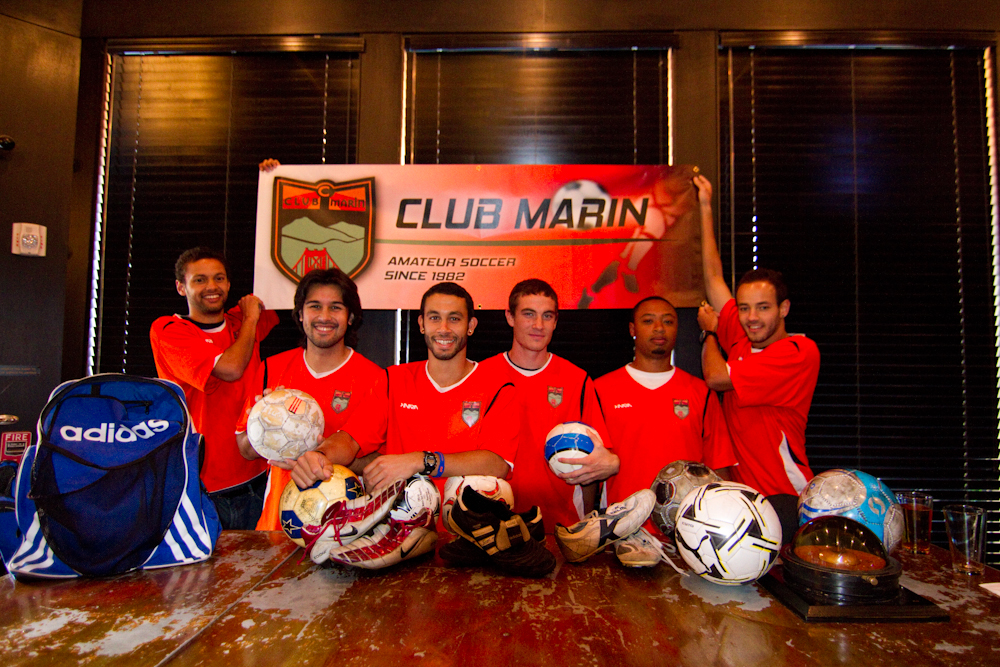 Players in front of a Soccer Without Borders donations banner